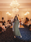 Model styling the Olive Fleur dress with the floral lace outer layer