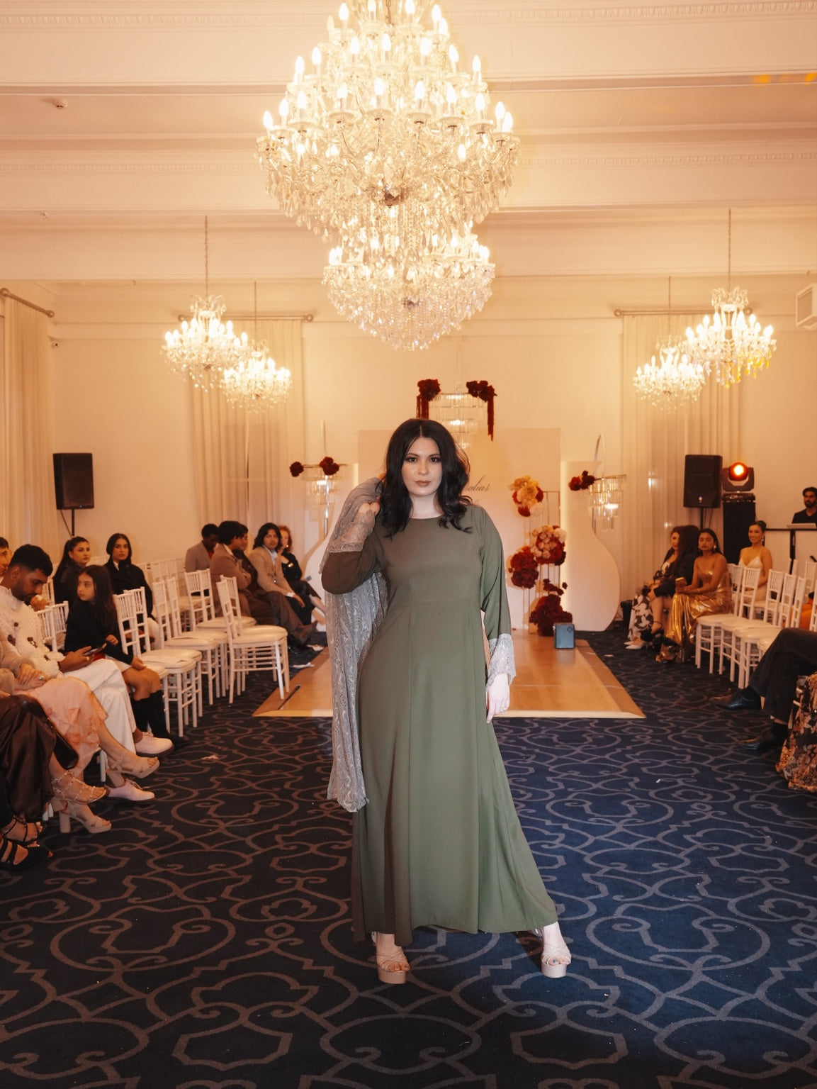 Model styling the Olive Fleur dress with the floral lace outer layer