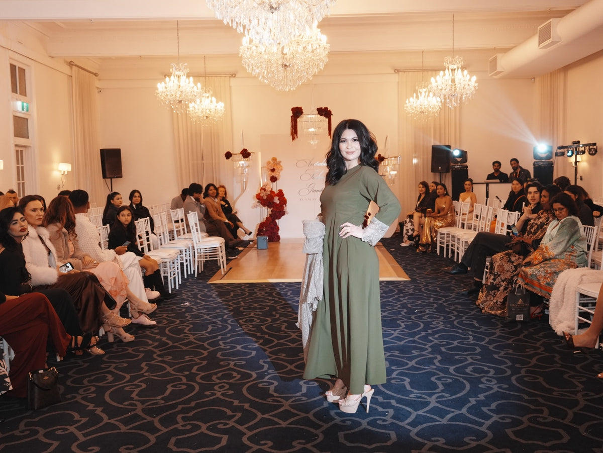 Model wearing the Olive Fleur inner dress on a runway